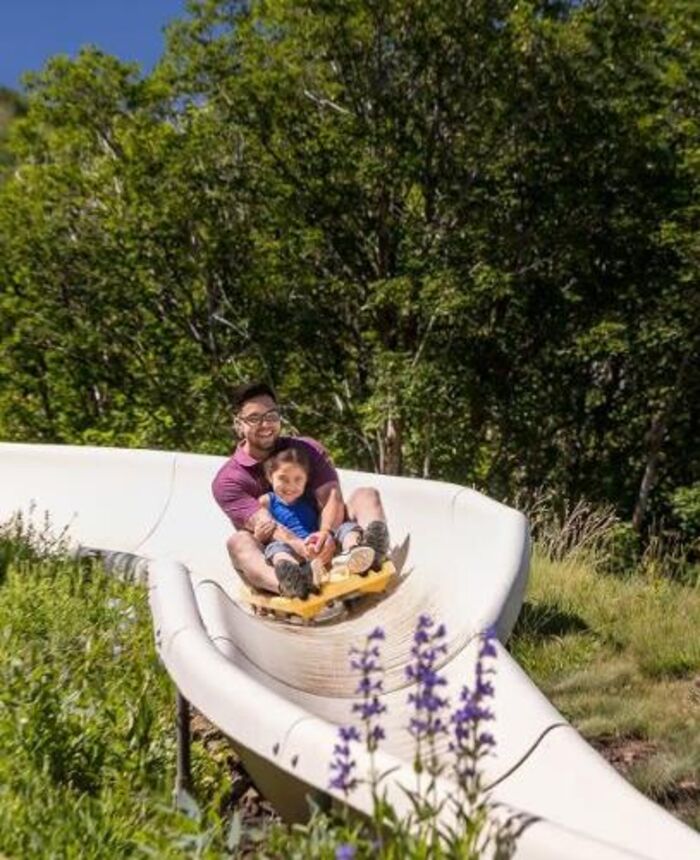 Family riding the alpine slide at Winter Park