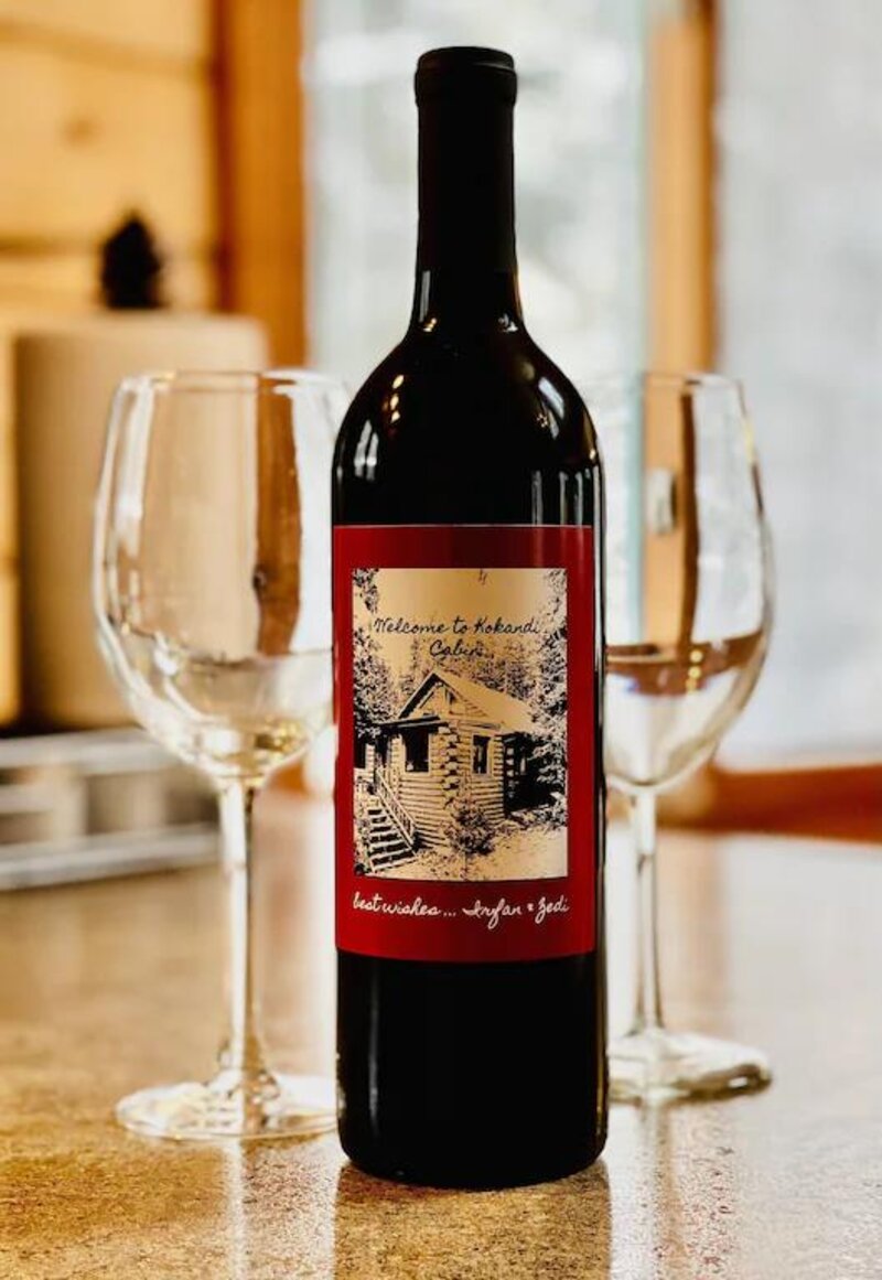 Bottle of wine with a custom Kokand Cabin label, welcome gift for guests